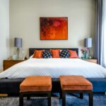 A luxury bedroom with warm accents and curated art